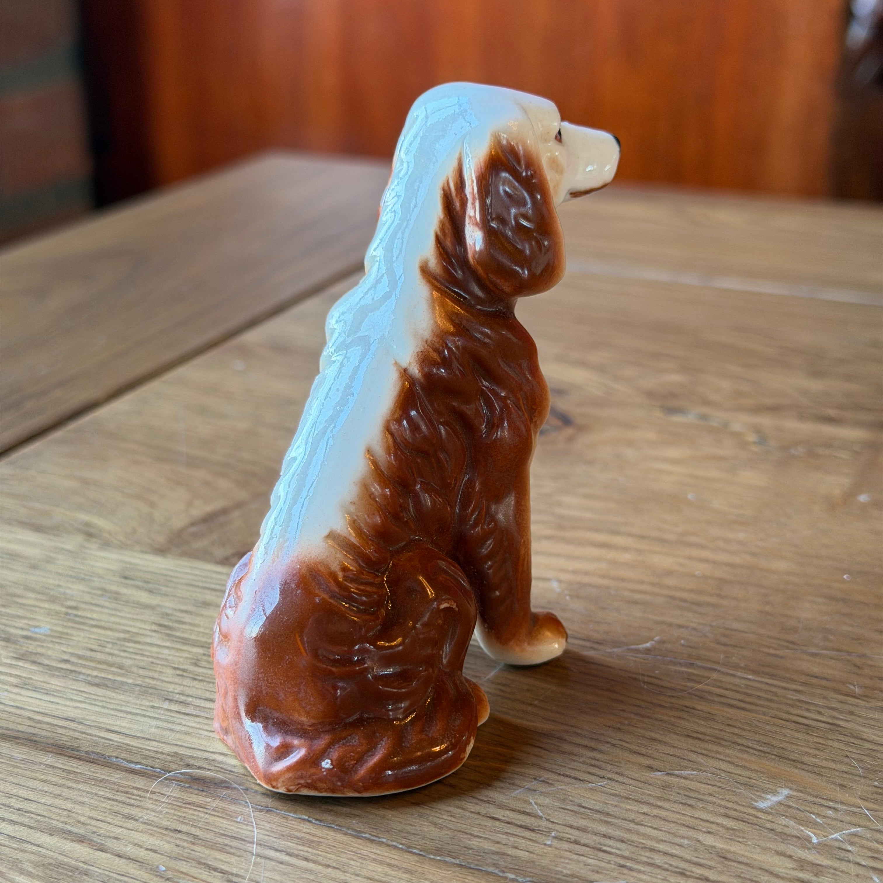 Porcelain dog sculpture – seated vintage dog statue