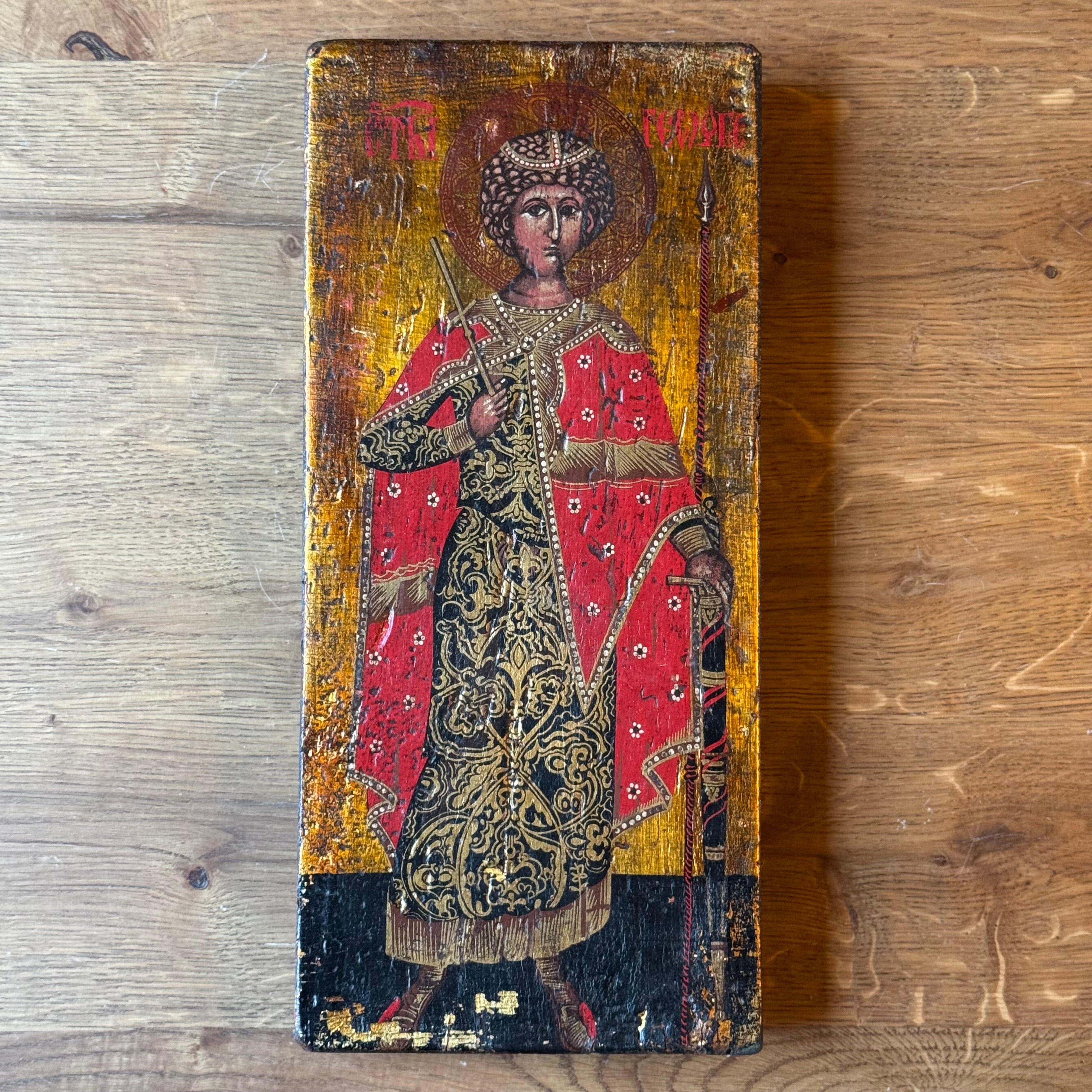 Icon of Saint George in richly decorated robes on wooden panel