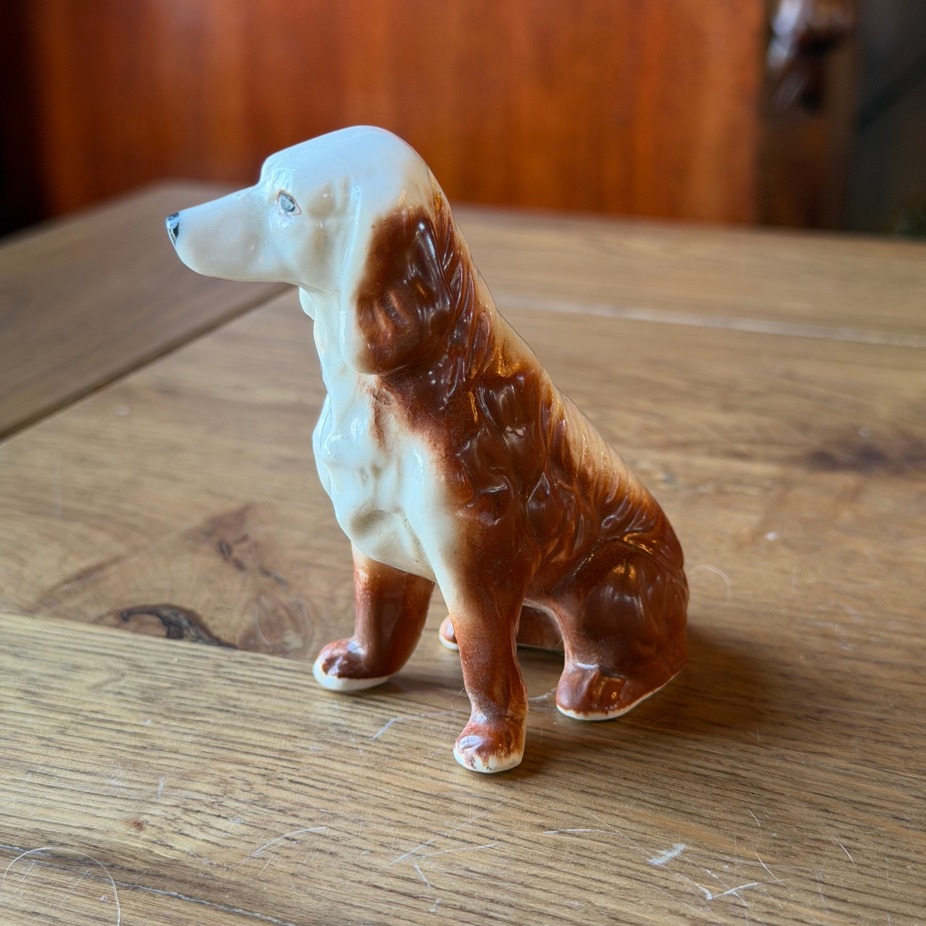 Porcelain dog sculpture – seated vintage dog statue