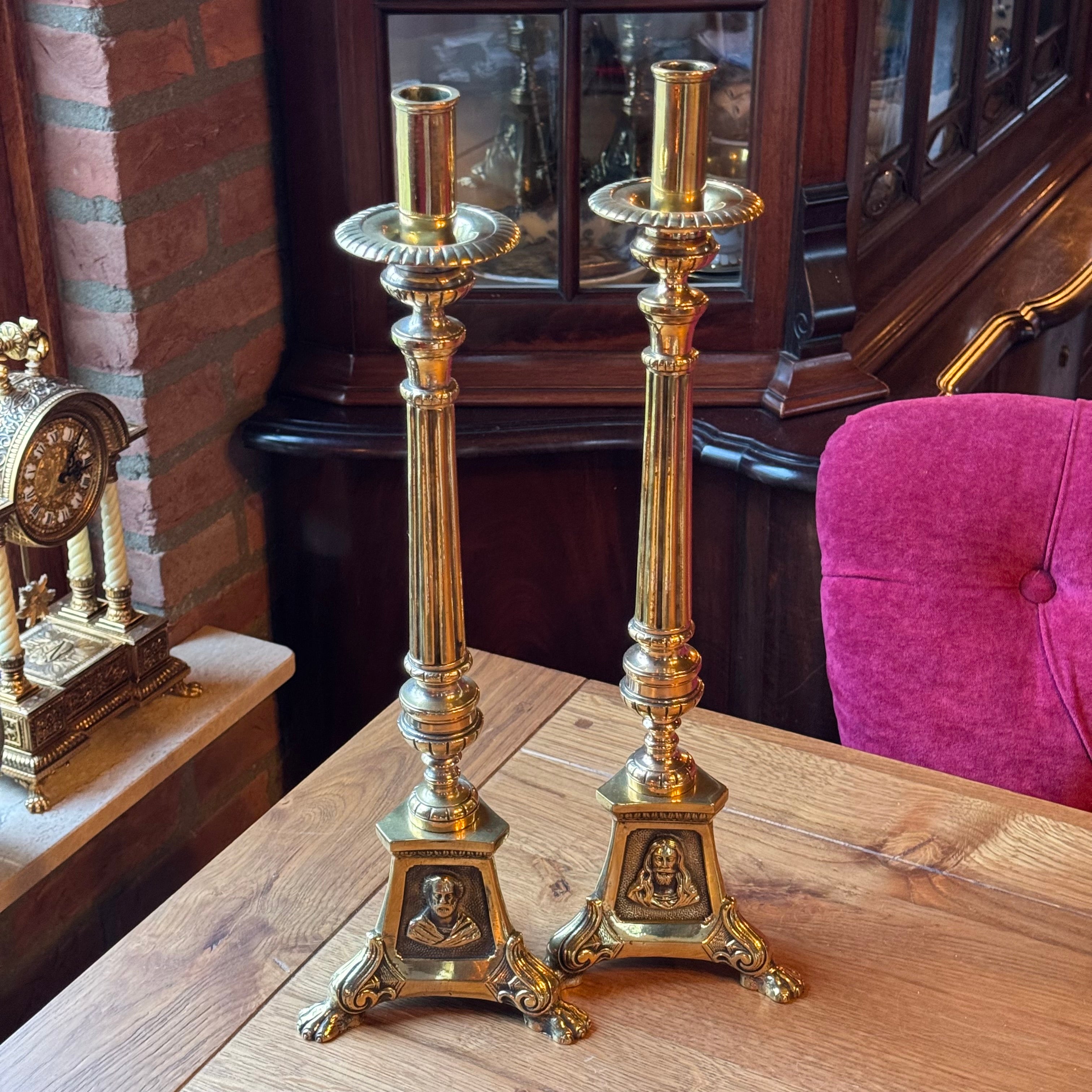 Antique ecclesiastical brass candlesticks with saints – set of 2
