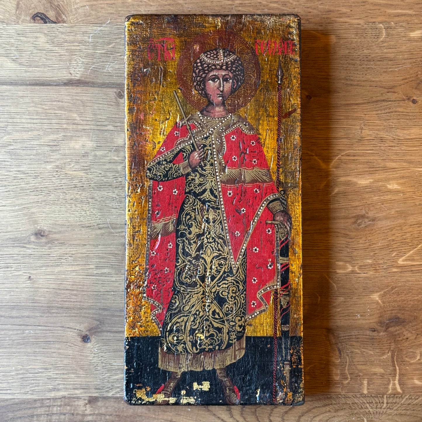 Icon of Saint George in richly decorated robes on wooden panel