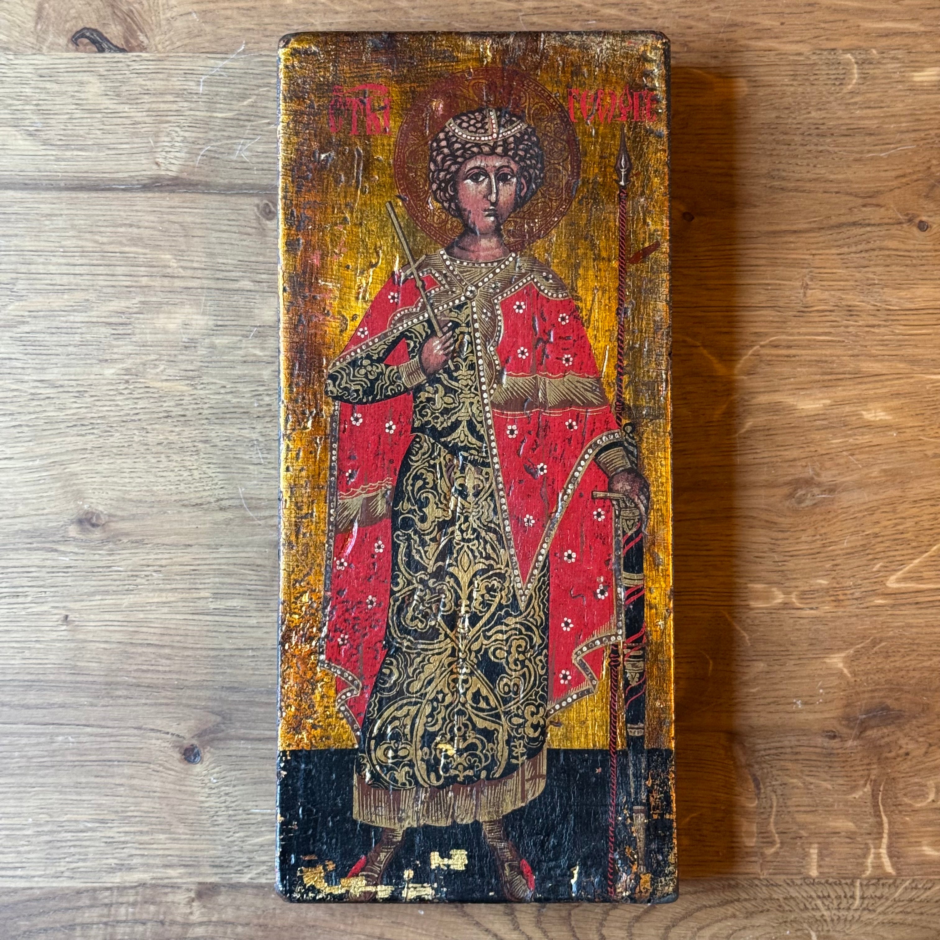 Icon of Saint George in richly decorated robes on wooden panel