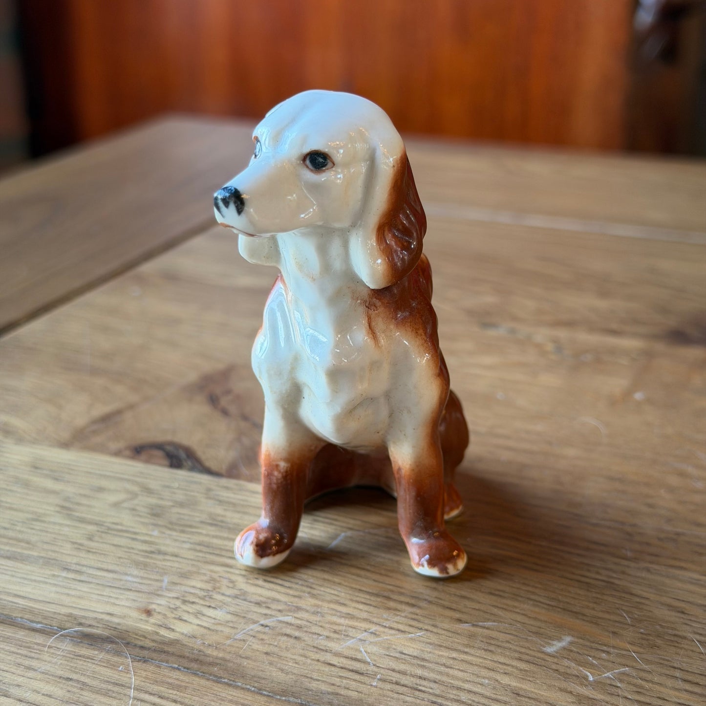 Porcelain dog sculpture – seated vintage dog statue