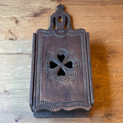 Wooden wall cabinet with carved clover pattern