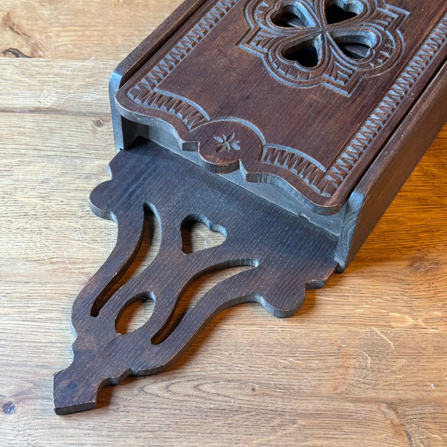 Wooden wall cabinet with carved clover pattern