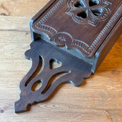Wooden wall cabinet with carved clover pattern