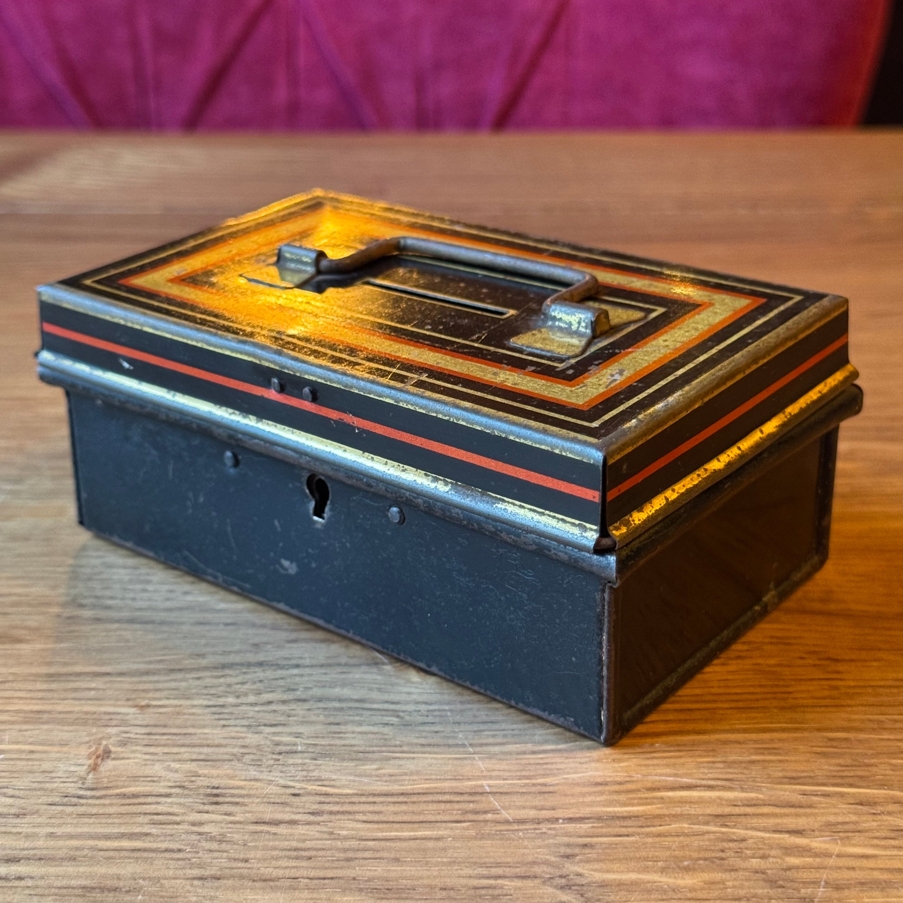 Vintage Metal Savings or Document Box with Key – Black with Gold/Red Decor (ca. 1920–1935)