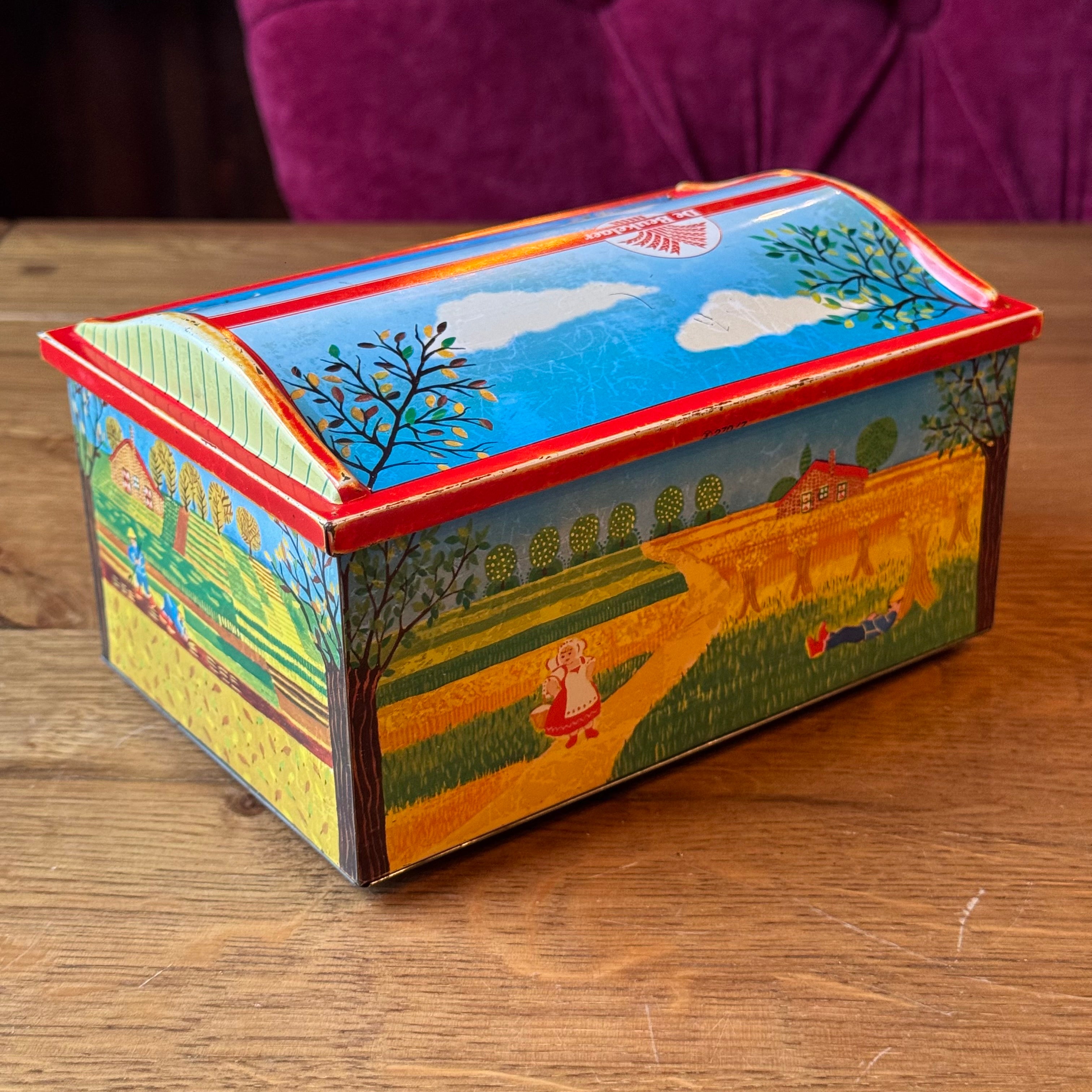 Vintage De Beukelaer tin drum with seasonal illustrations