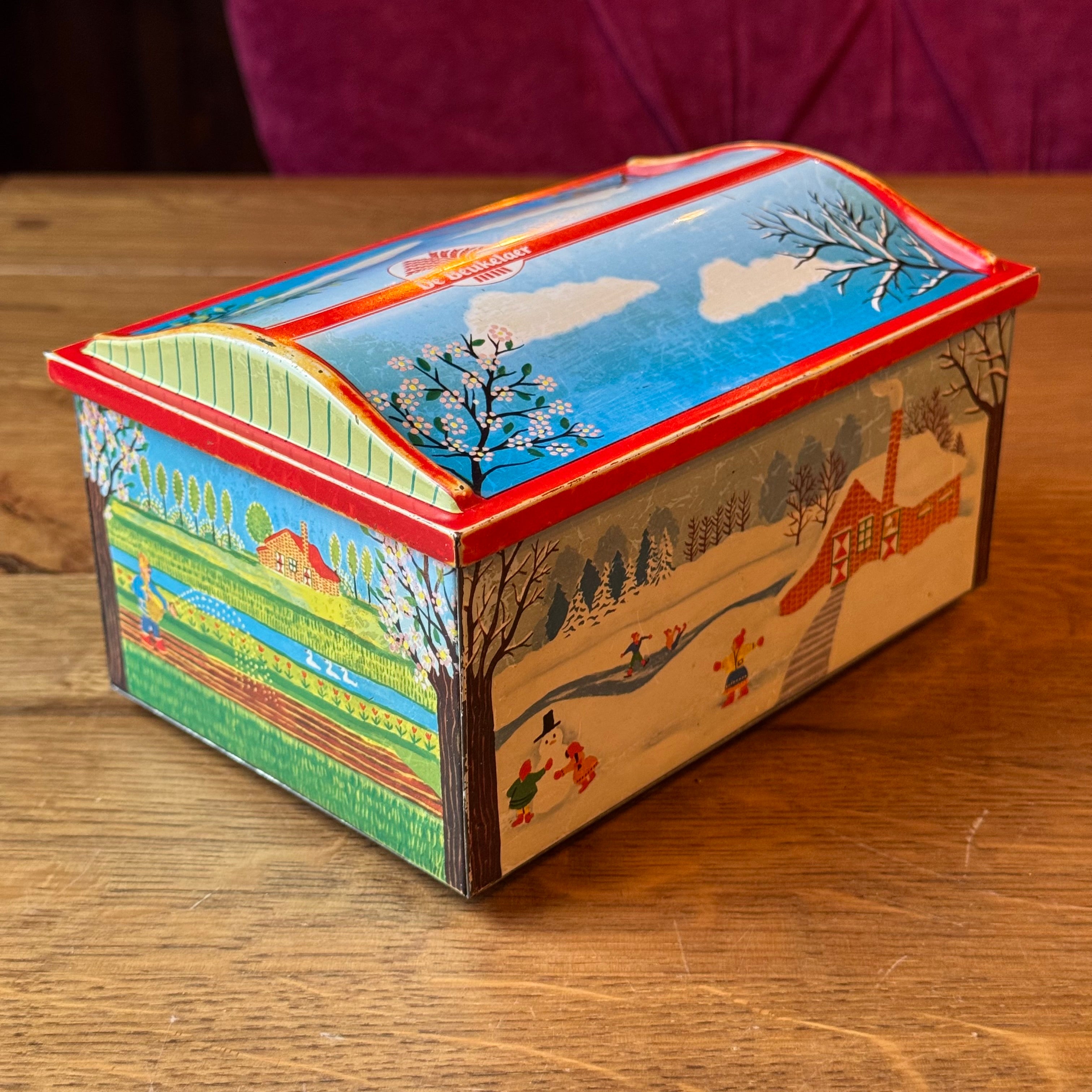 Vintage De Beukelaer tin drum with seasonal illustrations