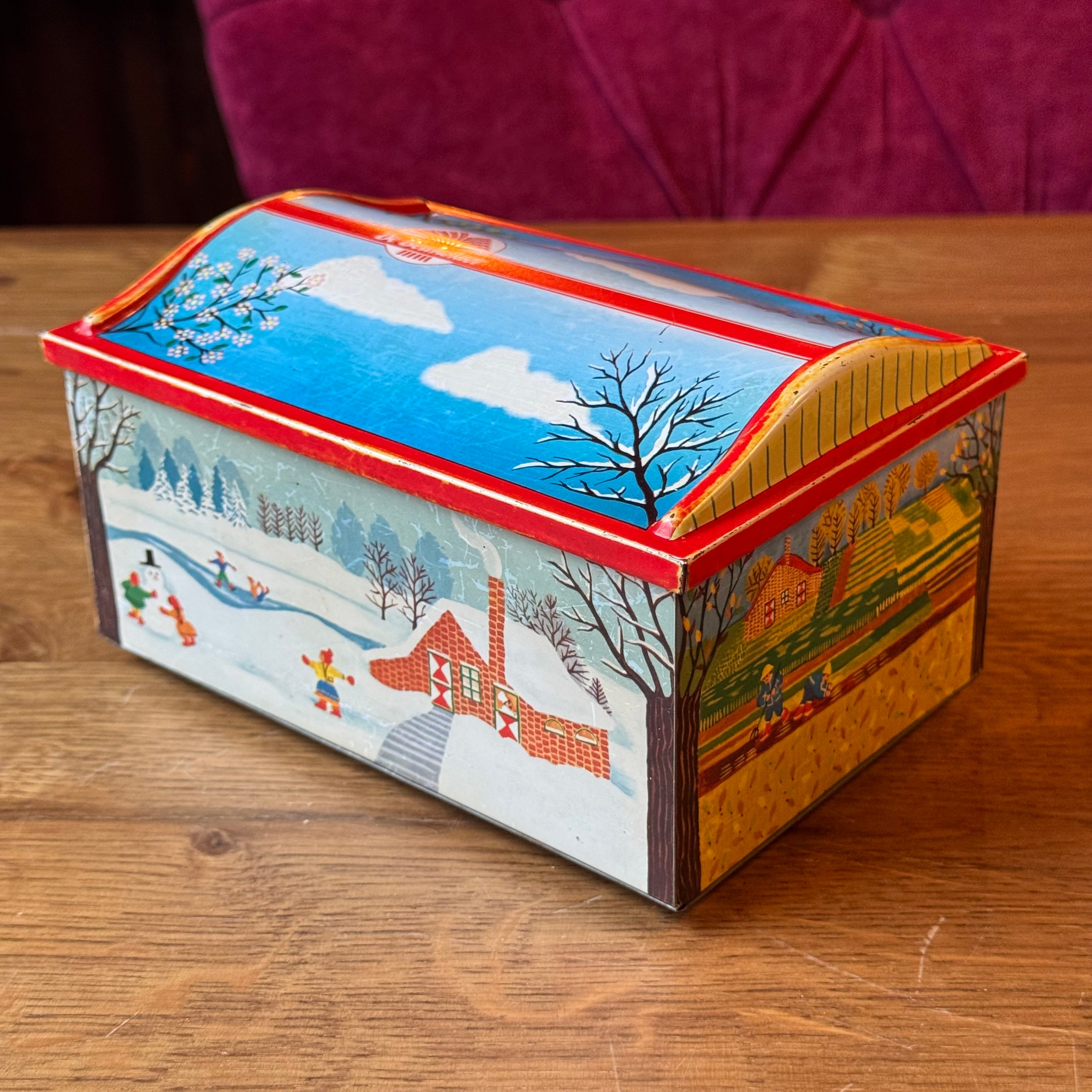 Vintage De Beukelaer tin drum with seasonal illustrations