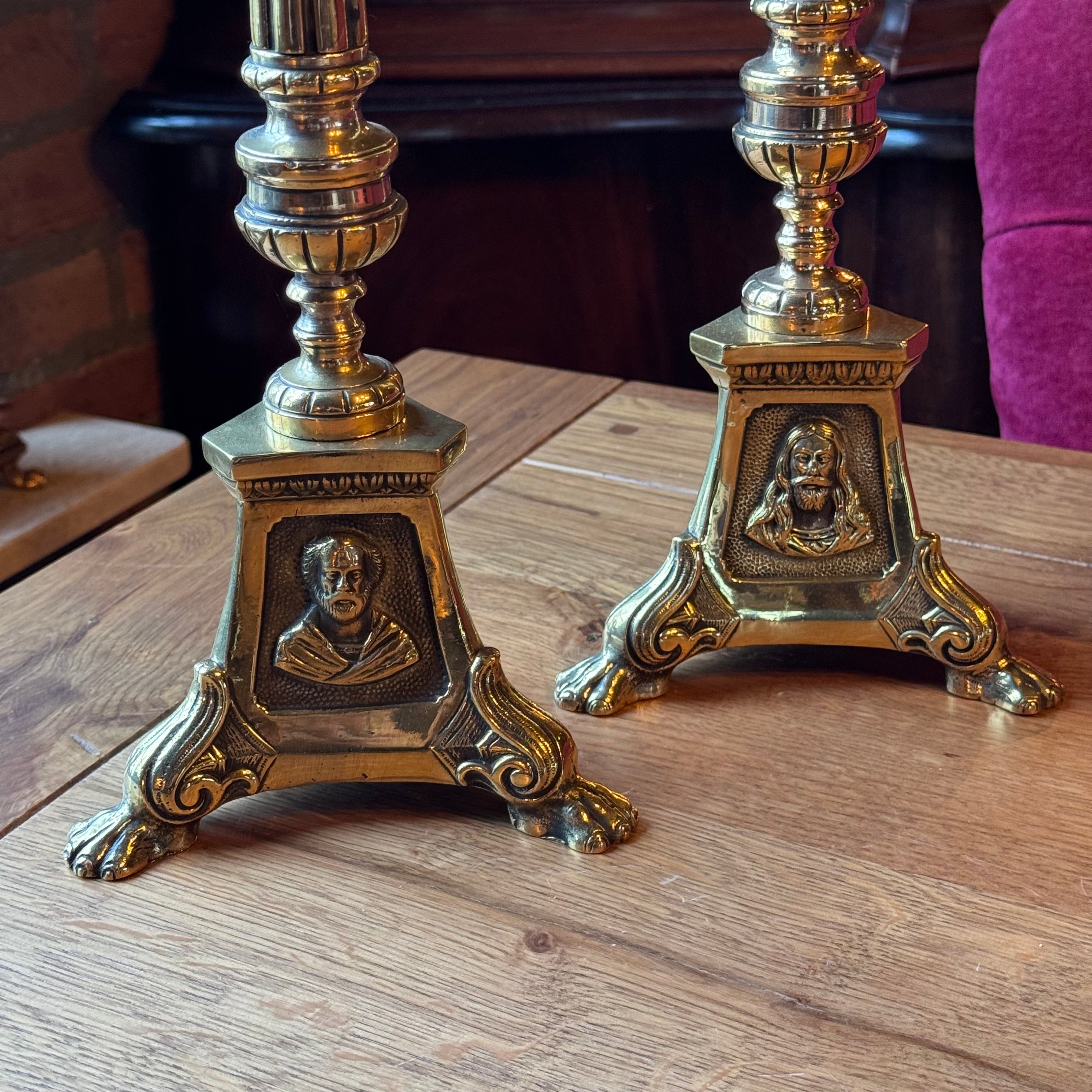 Antique ecclesiastical brass candlesticks with saints – set of 2
