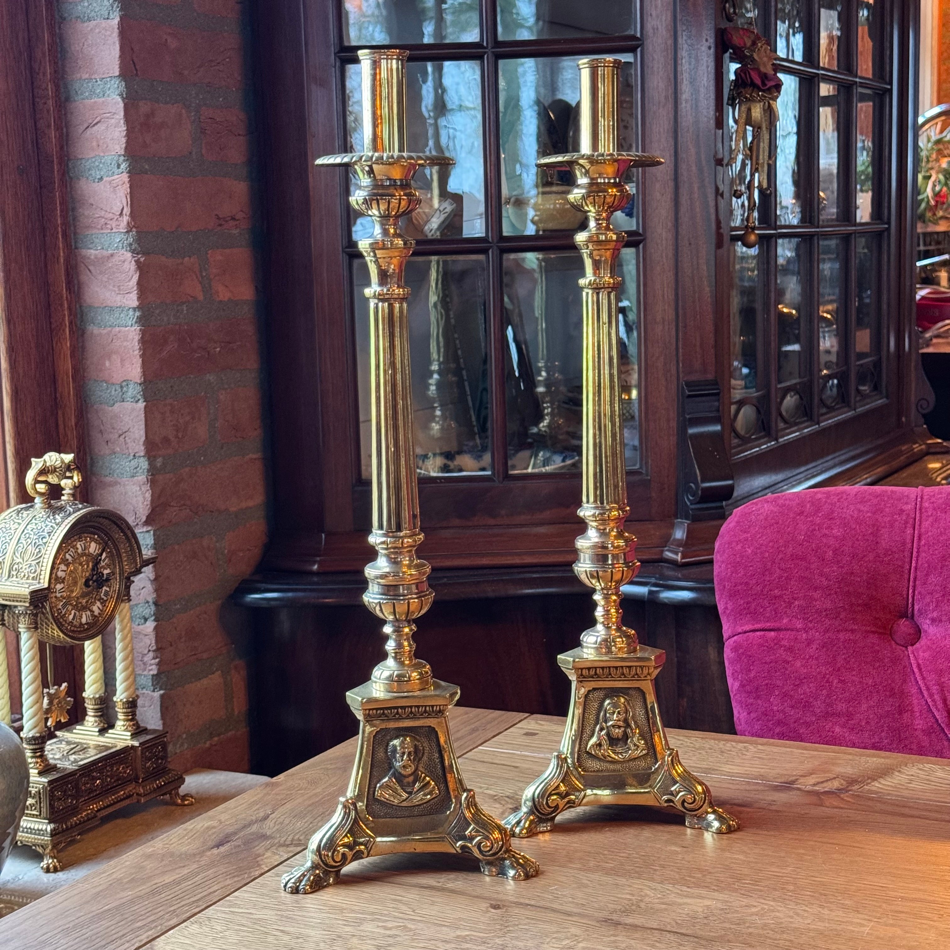 Antique ecclesiastical brass candlesticks with saints – set of 2