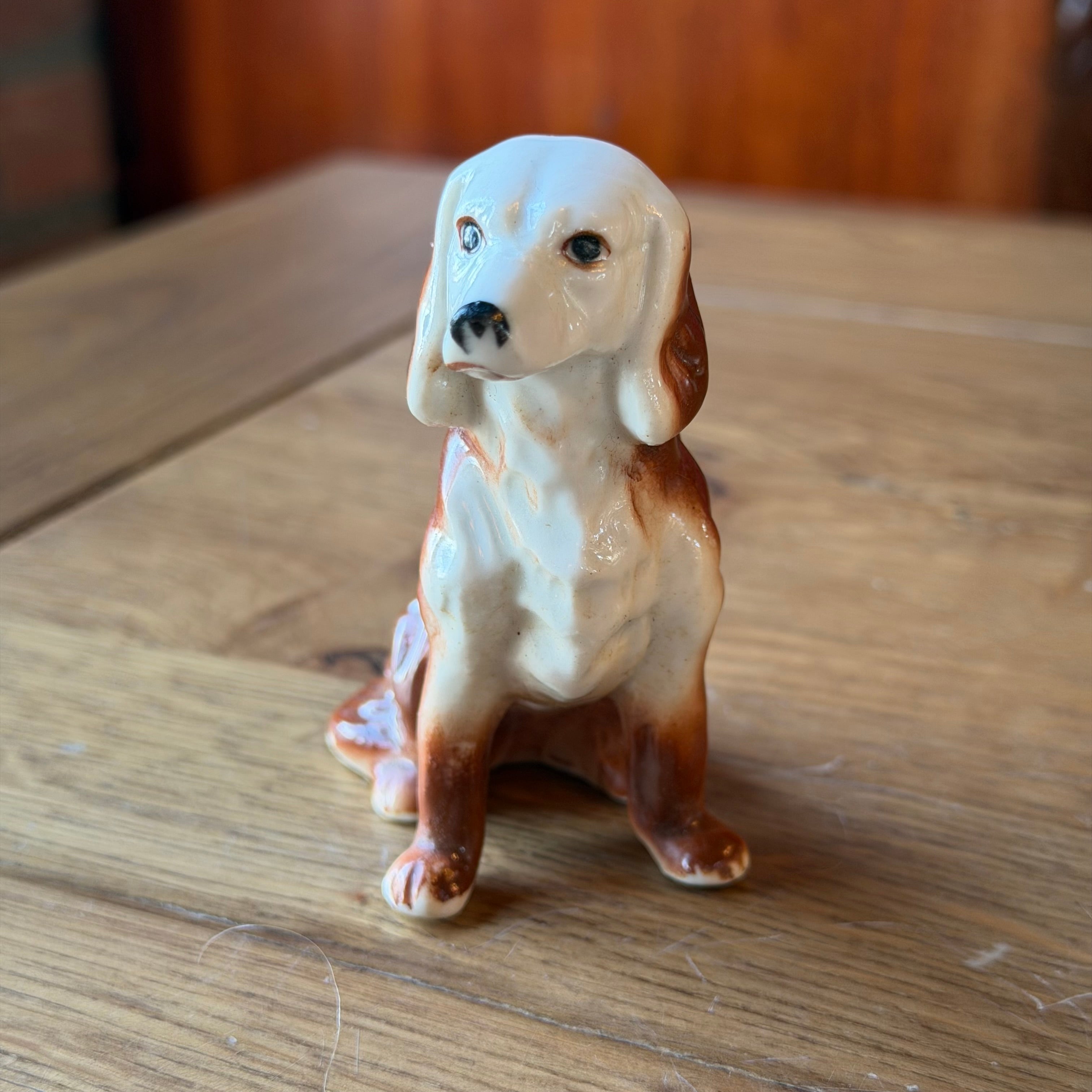 Porcelain dog sculpture – seated vintage dog statue
