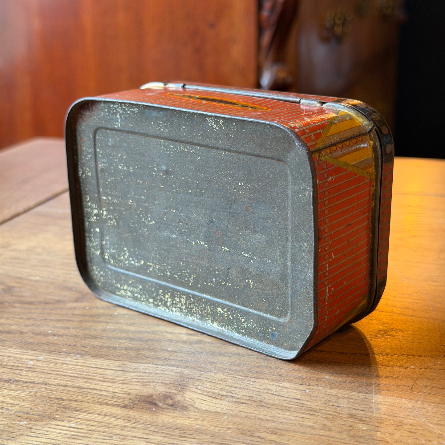 Old rectangular red tin with decorative pattern