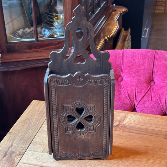Wooden wall cabinet with carved clover pattern